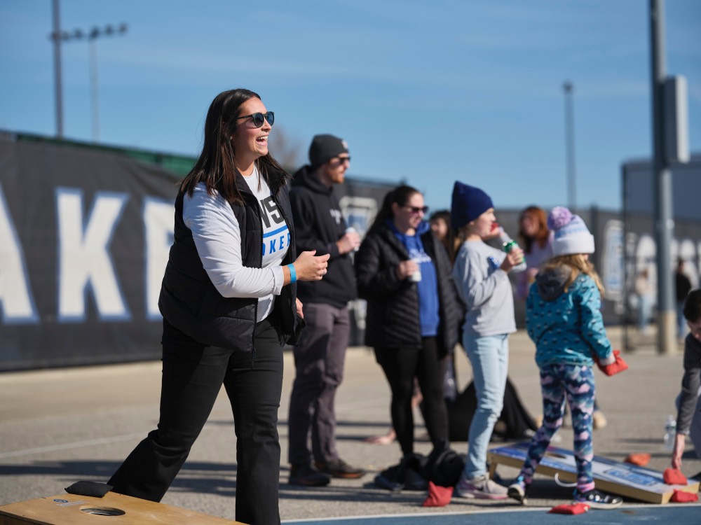 Girl smiling during corn hole game